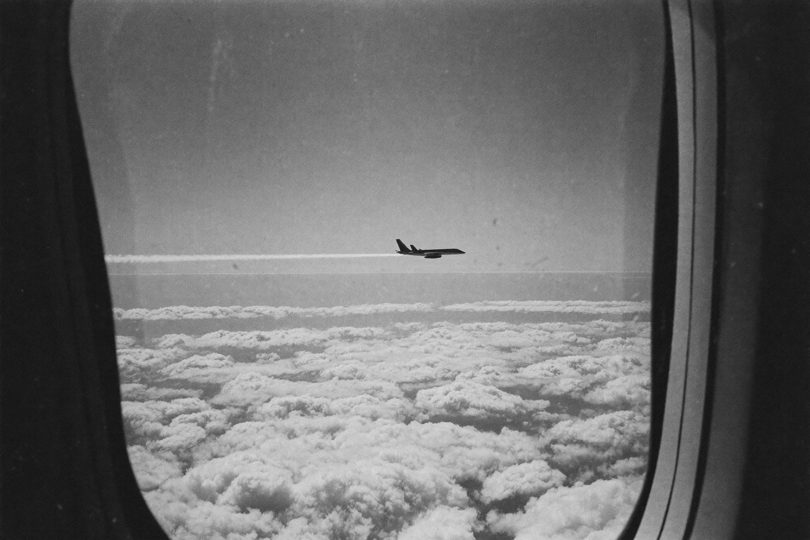 機窓から見た雲海と航空機（モノクロ）